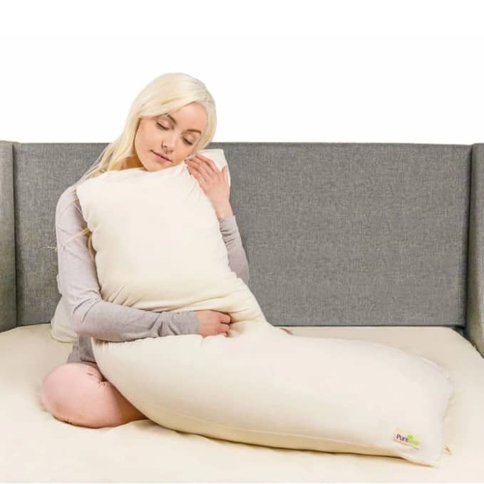 woman holding organic latex pillow after reading puretree review