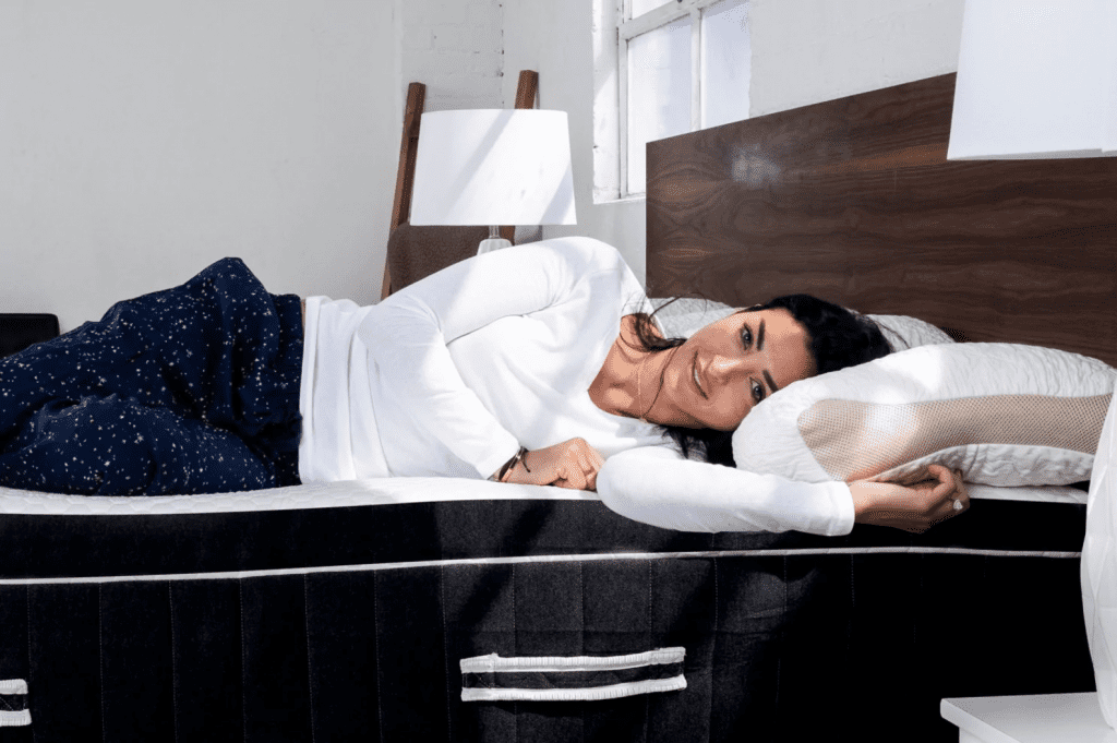 woman sleepin on posture-improving mattress after reading Cake Style's Spinealign review