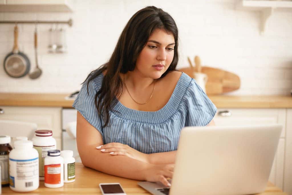 Woman reading the best Found Health weight loss program review as she decides to lose weight this year